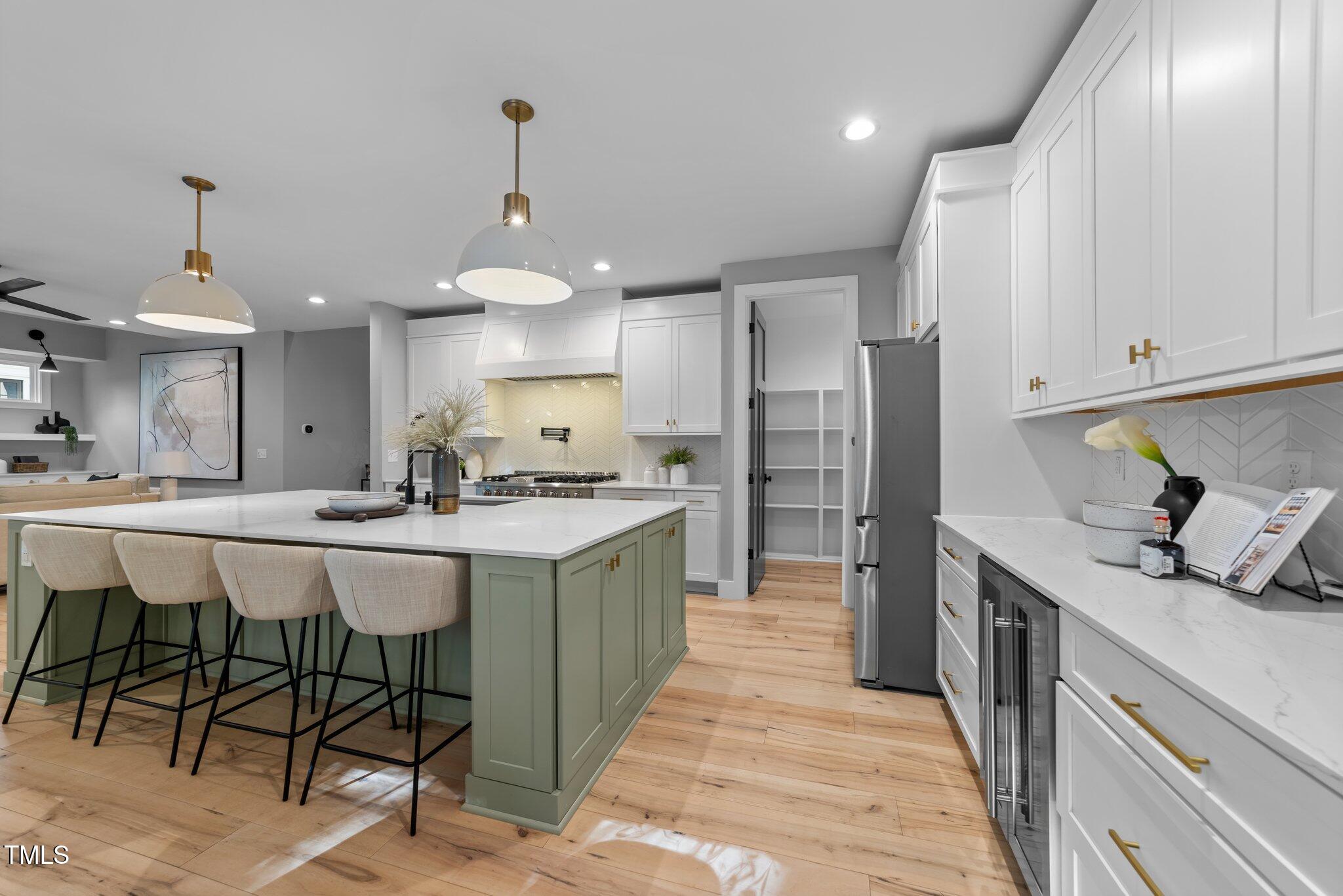 3316 Milton Road Raleigh, NC 27609 - Photo 17 of 50 a kitchen with stainless steel appliances granite countertop a sink refrigerator and cabinets