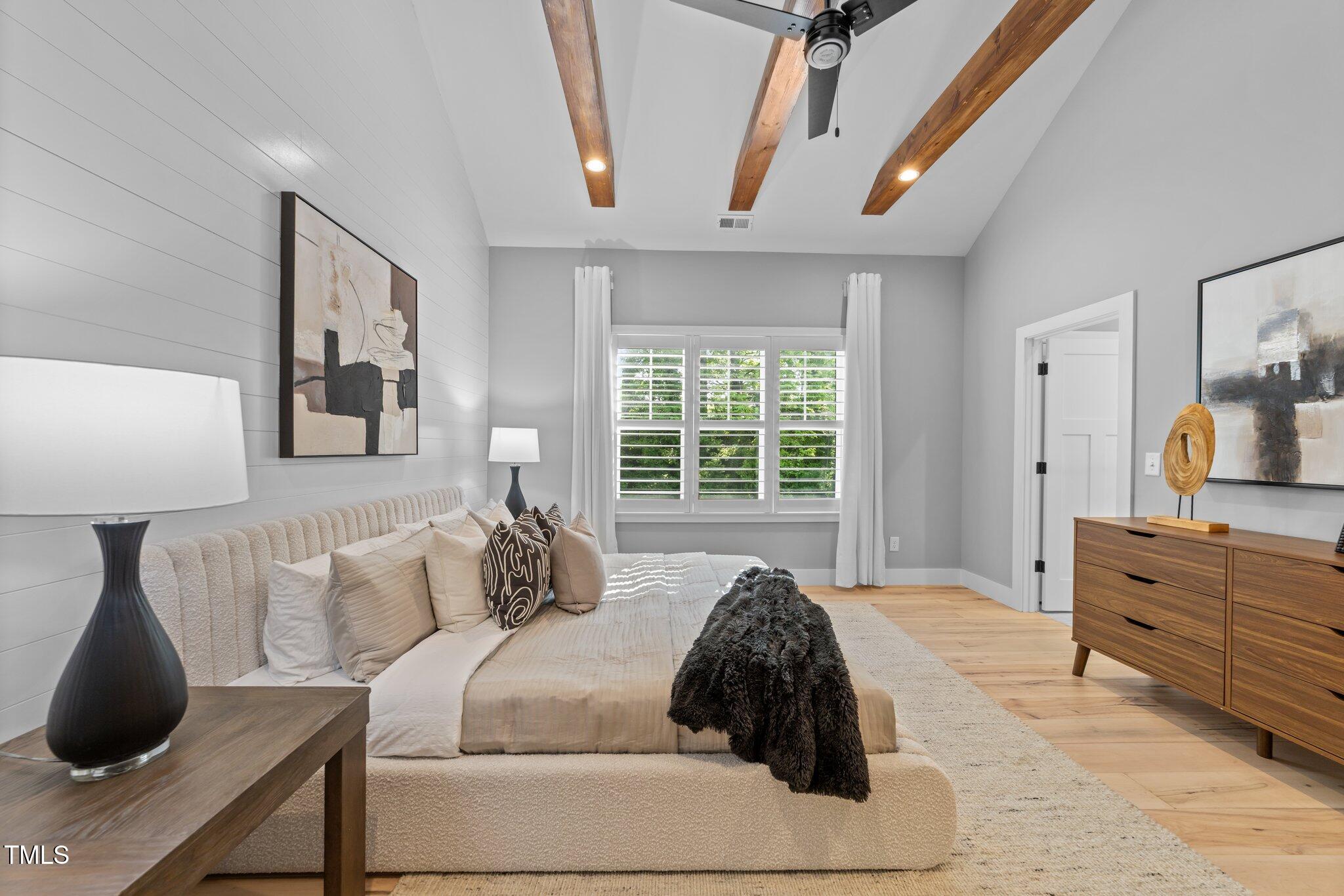 3316 Milton Road Raleigh, NC 27609 - Photo 22 of 50 a large bed sitting in a bedroom next to a window and dresser