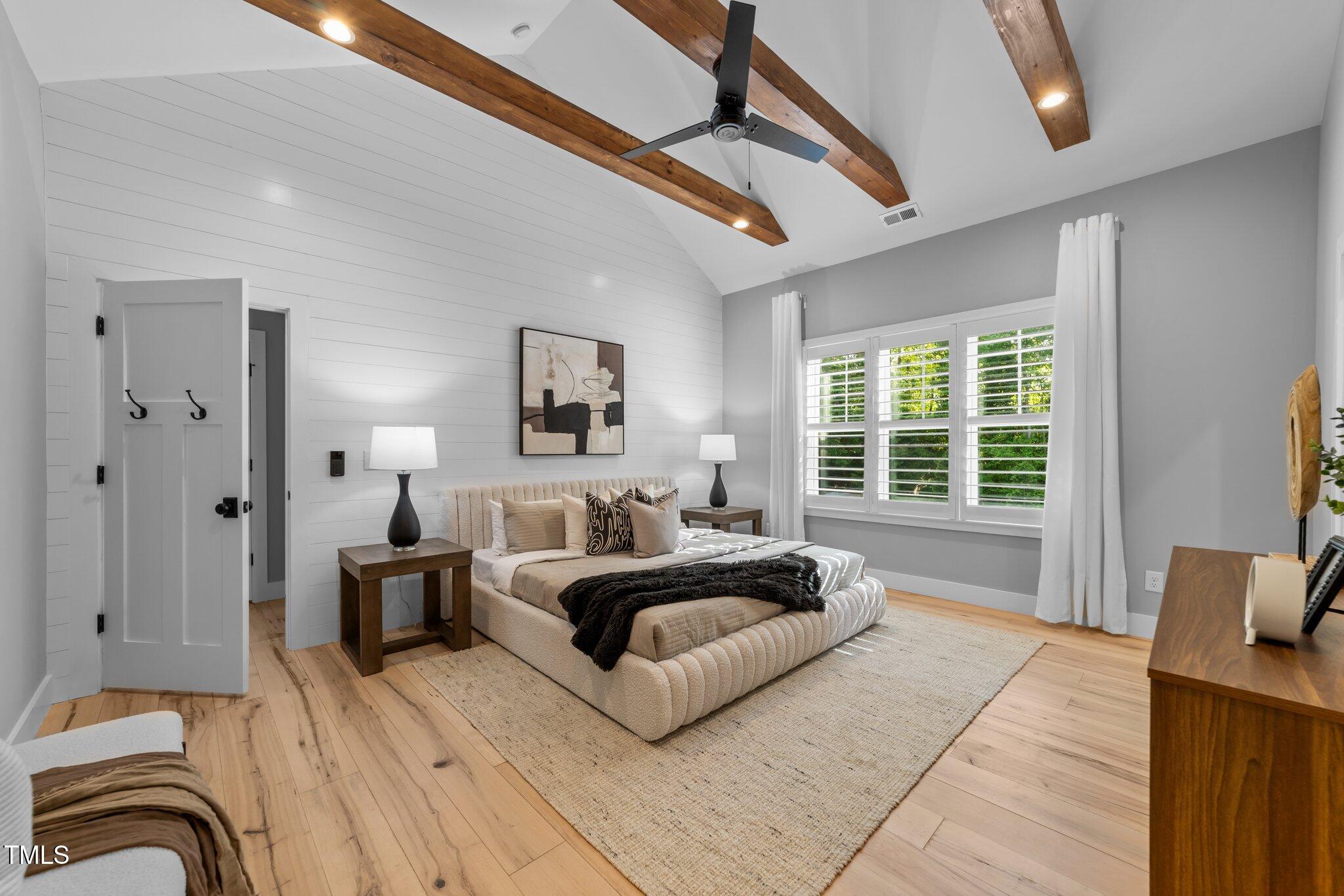 3316 Milton Road Raleigh, NC 27609 - Photo 23 of 50 a spacious bedroom with a bed a couch and a window