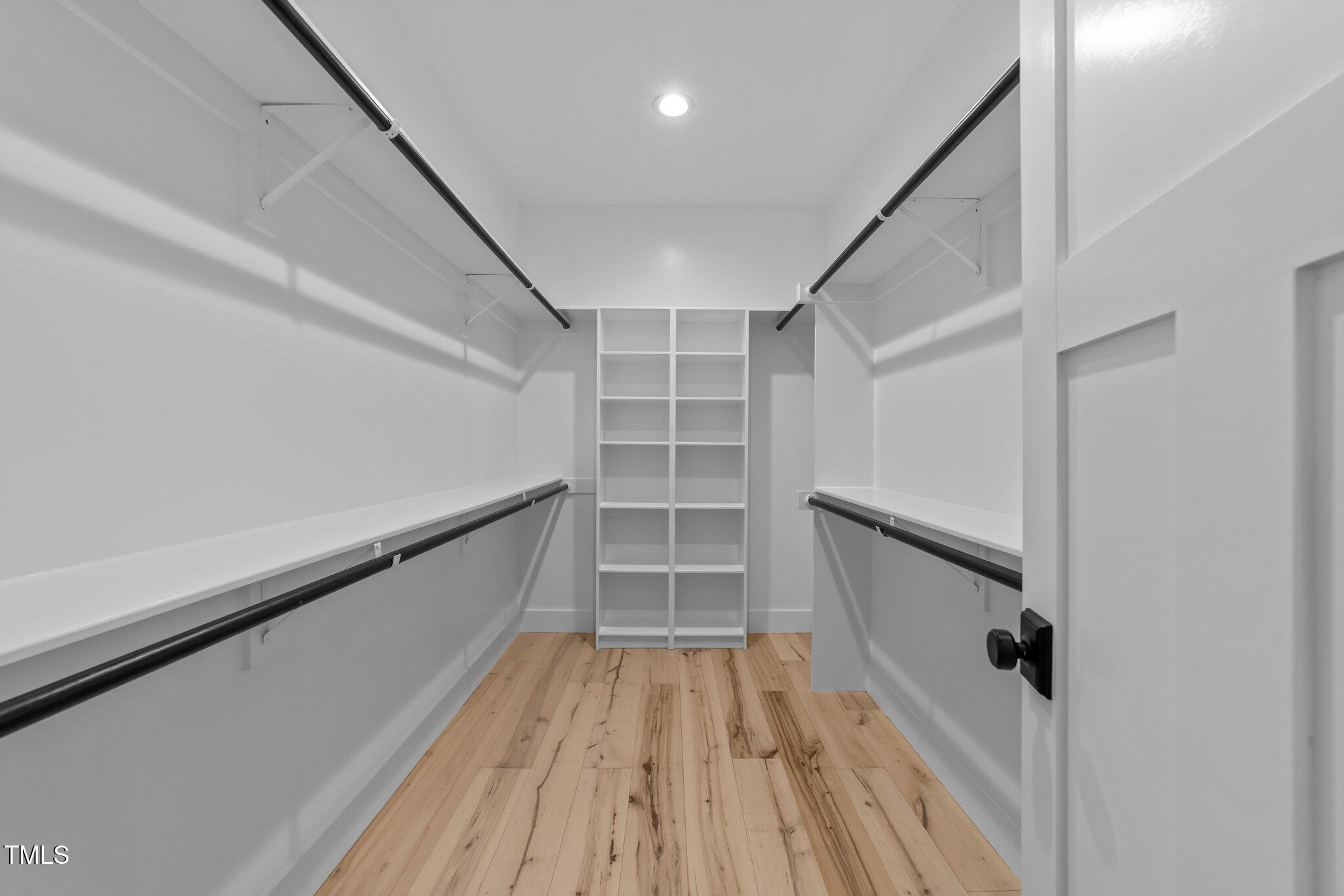 3316 Milton Road Raleigh, NC 27609 - Photo 24 of 50 a view of walk in closet with wooden floor