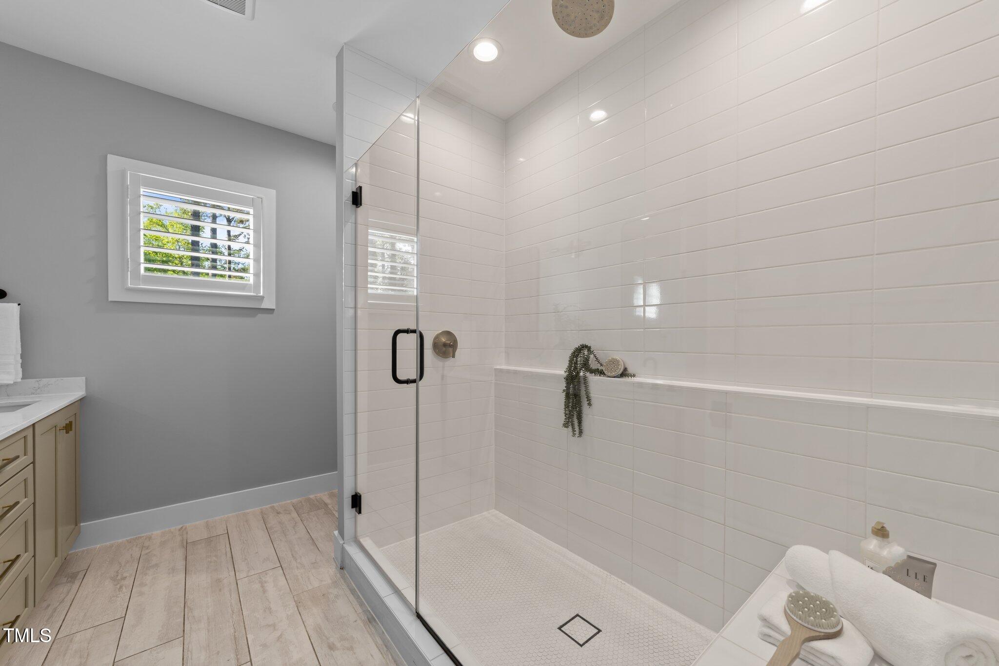 3316 Milton Road Raleigh, NC 27609 - Photo 26 of 50 a bathroom with a tub and shower