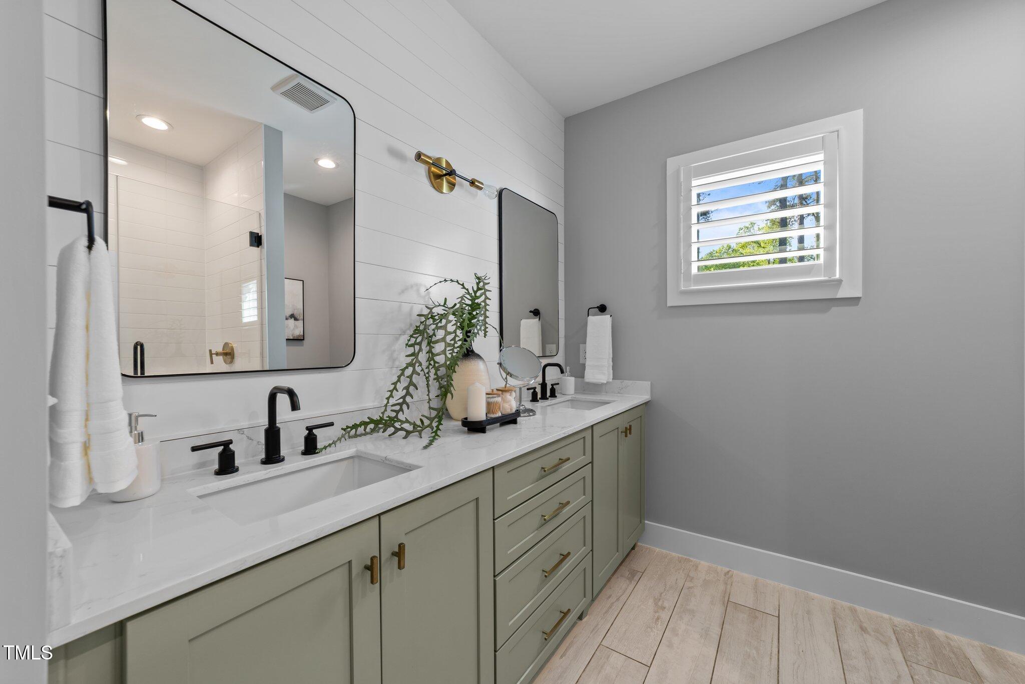 3316 Milton Road Raleigh, NC 27609 - Photo 27 of 50 a bathroom with a sink and a mirror
