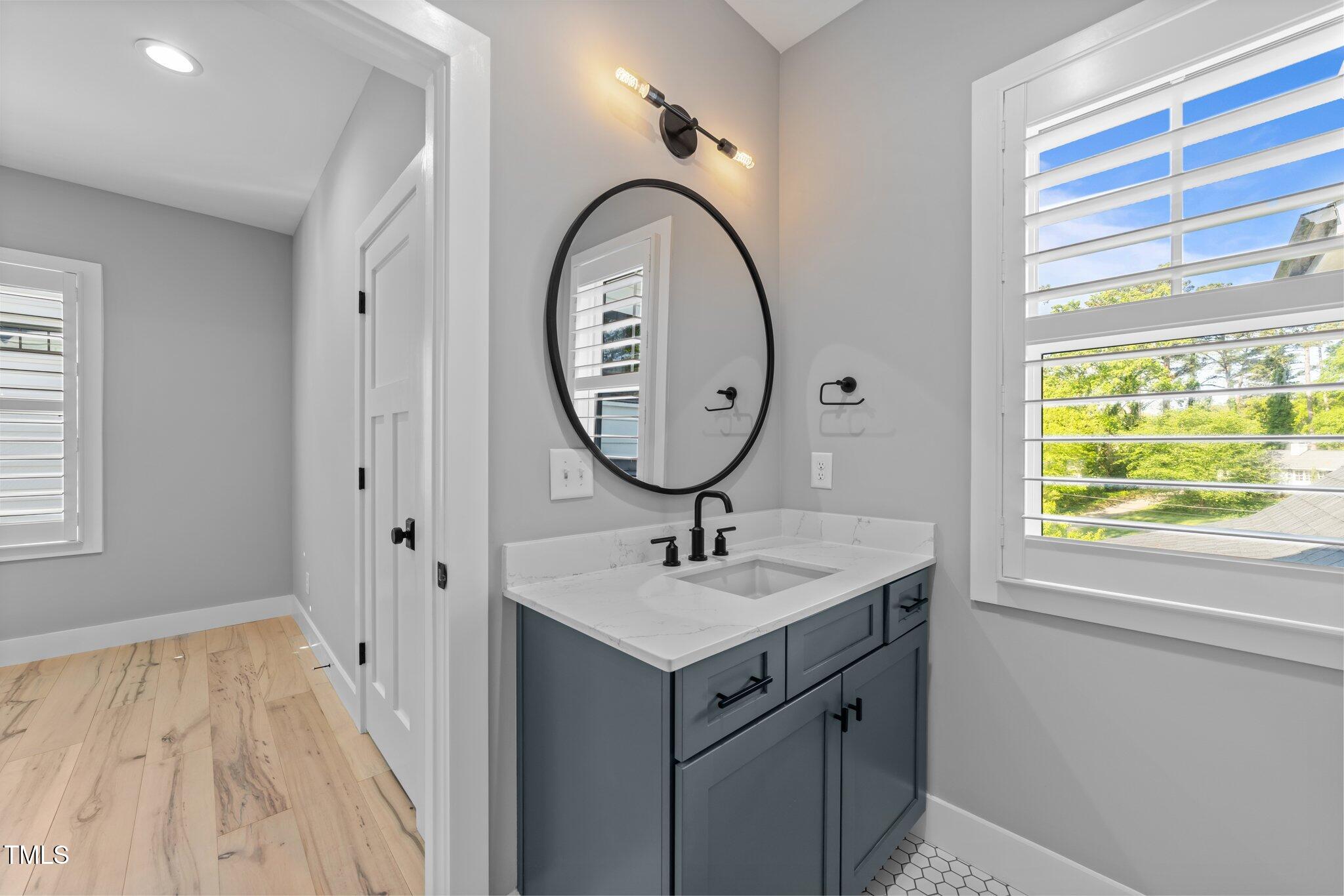 3316 Milton Road Raleigh, NC 27609 - Photo 31 of 50 a bathroom with a sink and a mirror