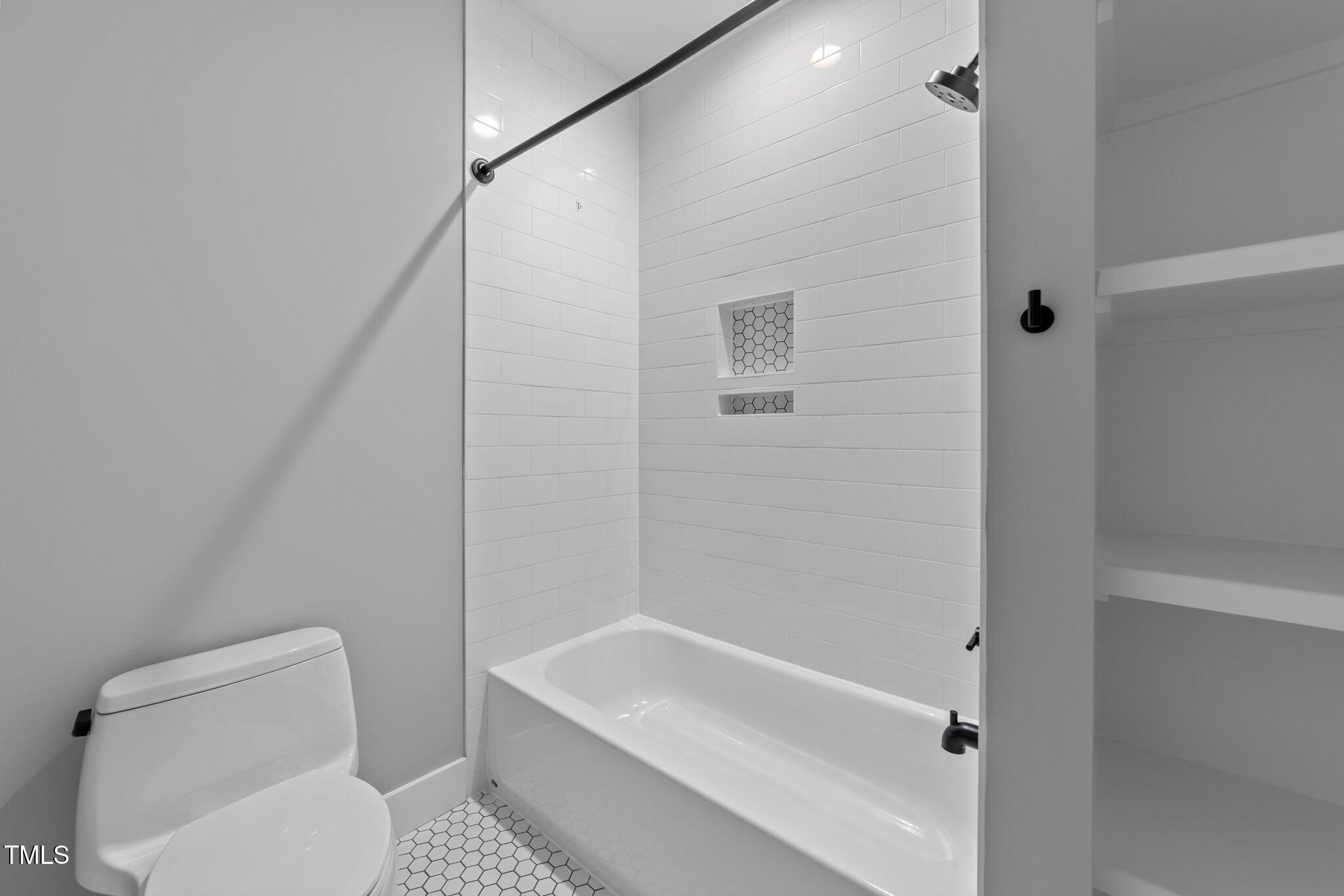 3316 Milton Road Raleigh, NC 27609 - Photo 32 of 50 a bathroom with a toilet and a bathtub