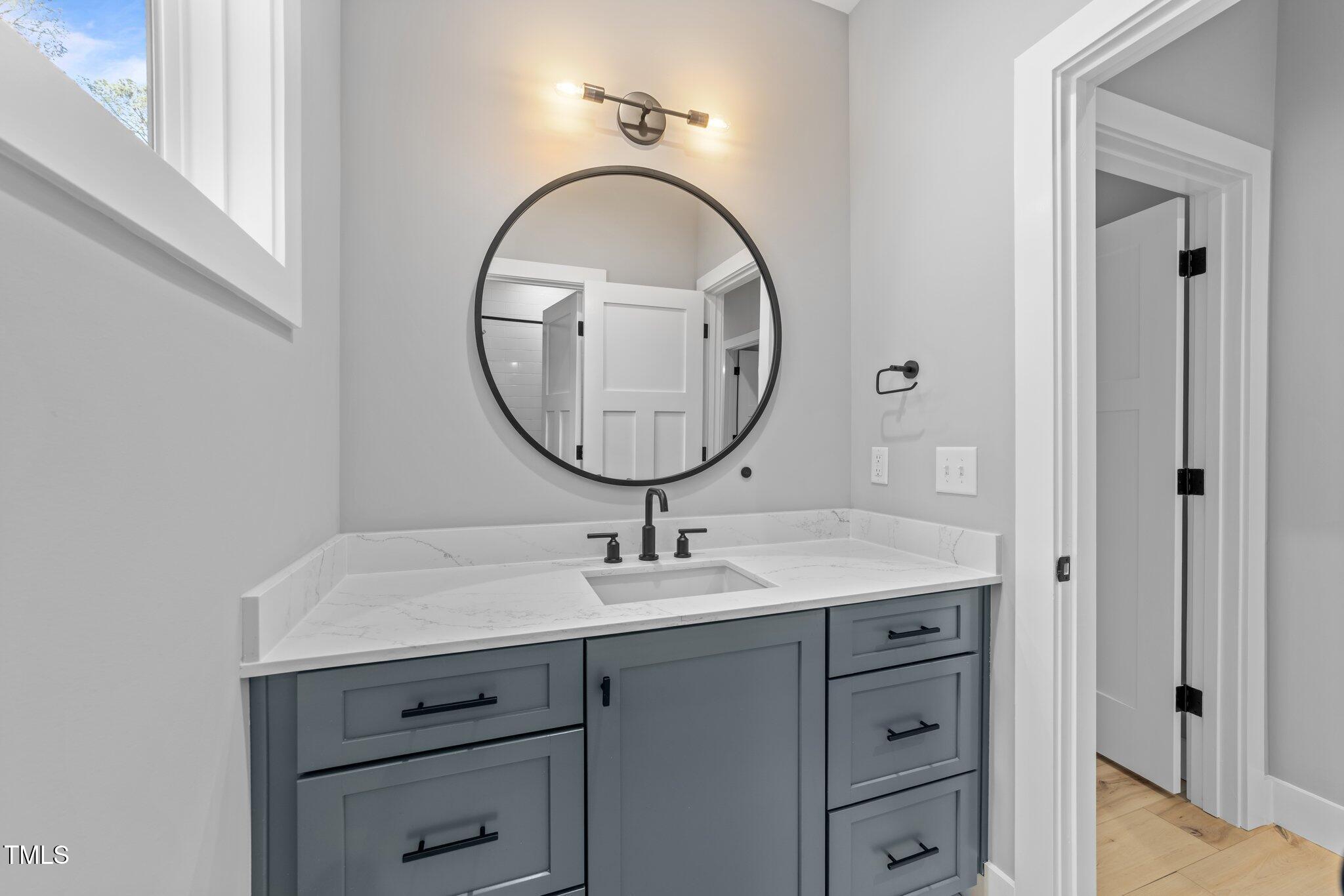 3316 Milton Road Raleigh, NC 27609 - Photo 33 of 50 a bathroom with a sink and a mirror