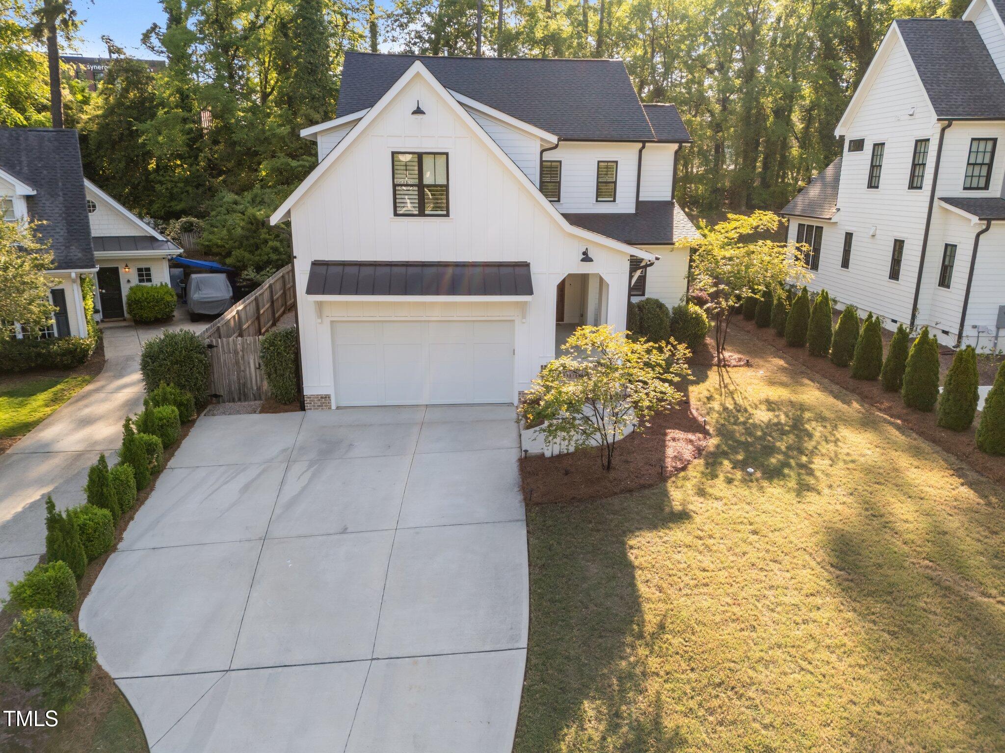 3316 Milton Road Raleigh, NC 27609 - Photo 45 of 50 a front view of a house with a yard and garage