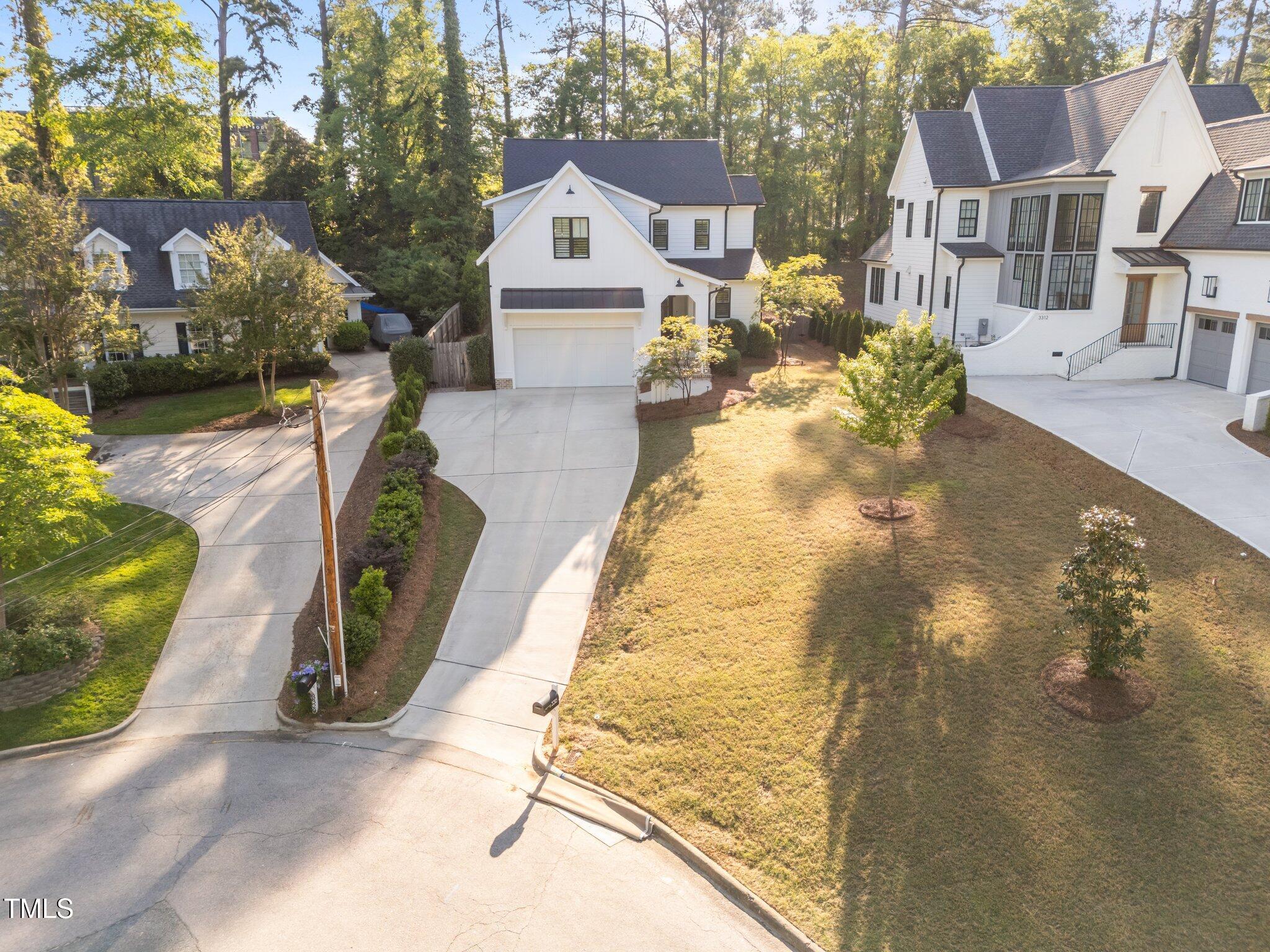 3316 Milton Road Raleigh, NC 27609 - Photo 46 of 50 a view of a white house with a yard