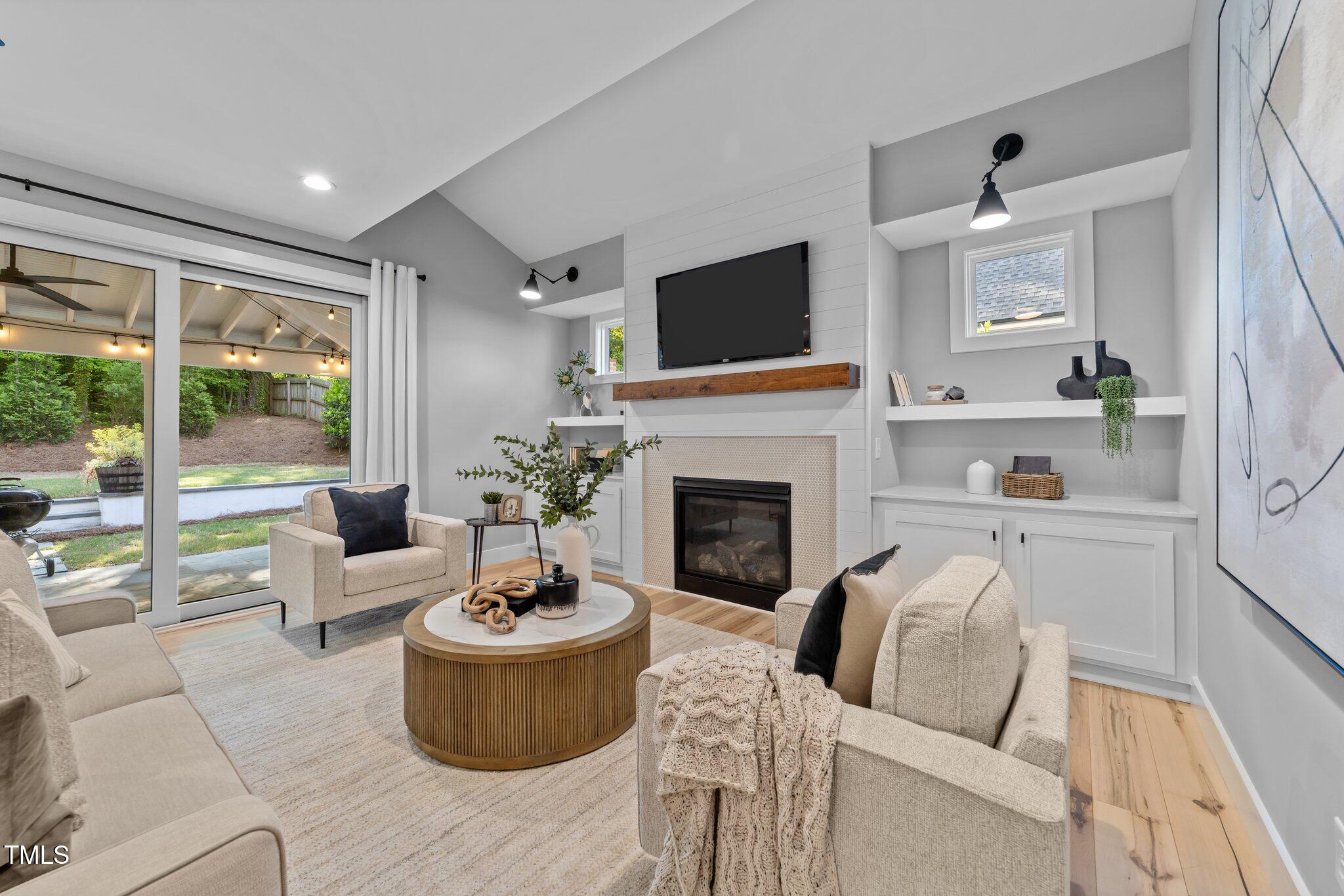 3316 Milton Road Raleigh, NC 27609 - Photo 10 of 50 a living room with furniture fireplace and a large window