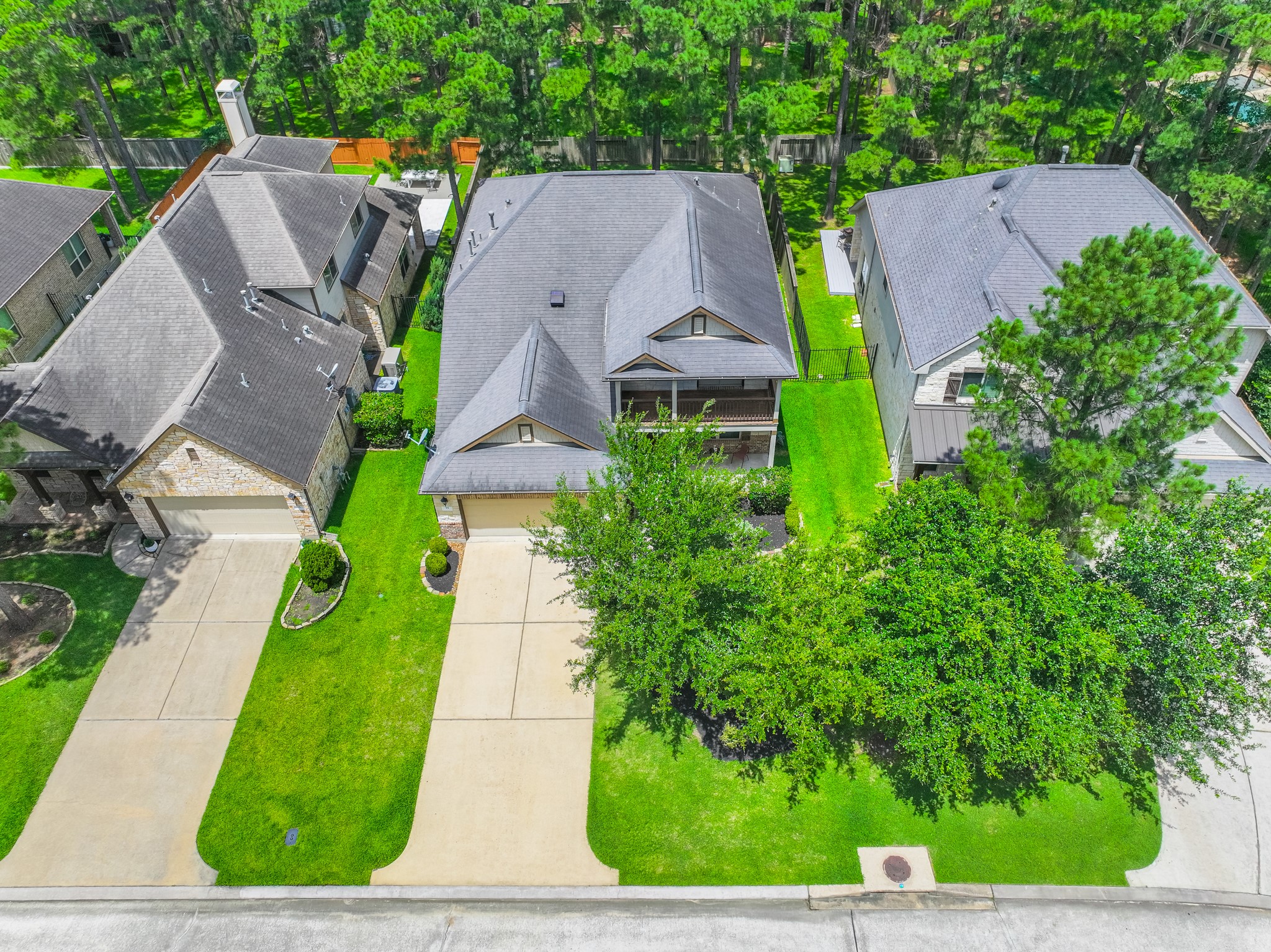 79 West Jagged Ridge Circle Spring, TX 77389 - Photo 46 of 50 This aerial view captures the home within its surrounding streetscape, showcasing the well-kept lawns, driveways, and mature landscaping that define this welcoming community. It's a great look at how this home fits beautifully into its established neighborhood.