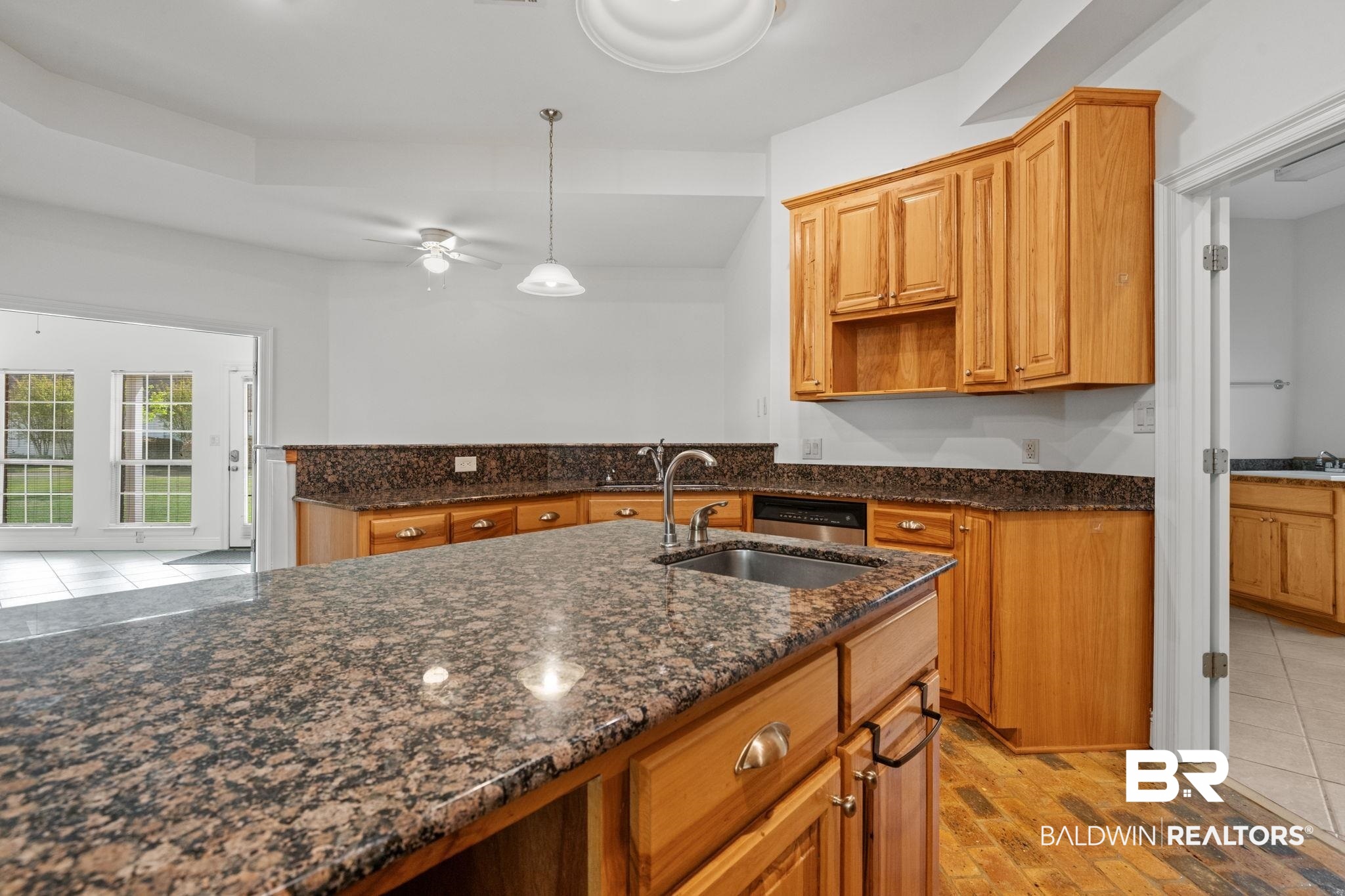 29634 St George Street Daphne, AL 36526 - Photo 21 of 47 Kitchen with dark stone countertops, ceiling fan, pendant lighting, and wood finish cabinetry