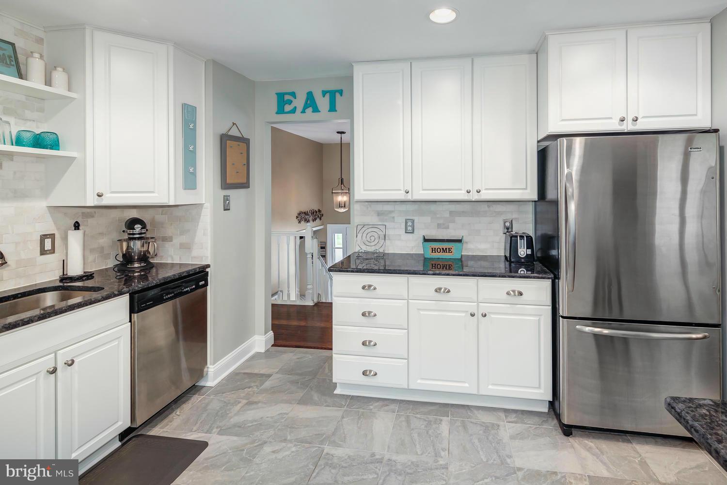 9148 Rockefeller Lane Springfield, VA 22153 - Photo 13 of 29 a kitchen with appliances a refrigerator and cabinets