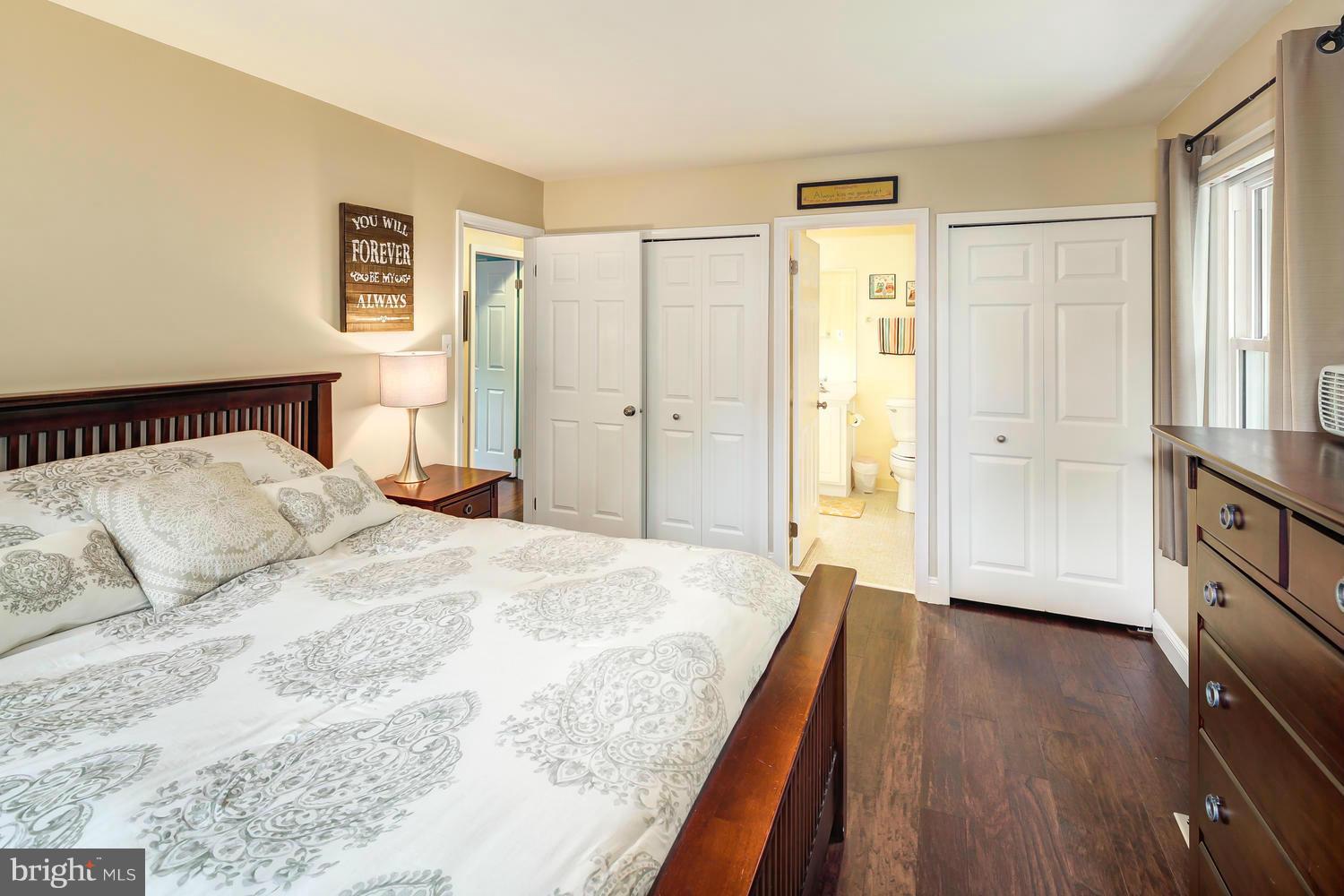 9148 Rockefeller Lane Springfield, VA 22153 - Photo 18 of 29 a spacious bedroom with a bed and wooden floor
