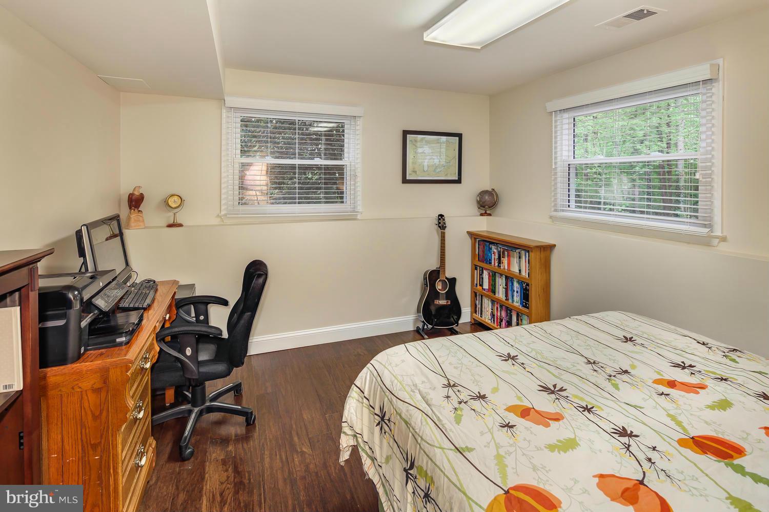 9148 Rockefeller Lane Springfield, VA 22153 - Photo 24 of 29 a bedroom with a bed and a table in it