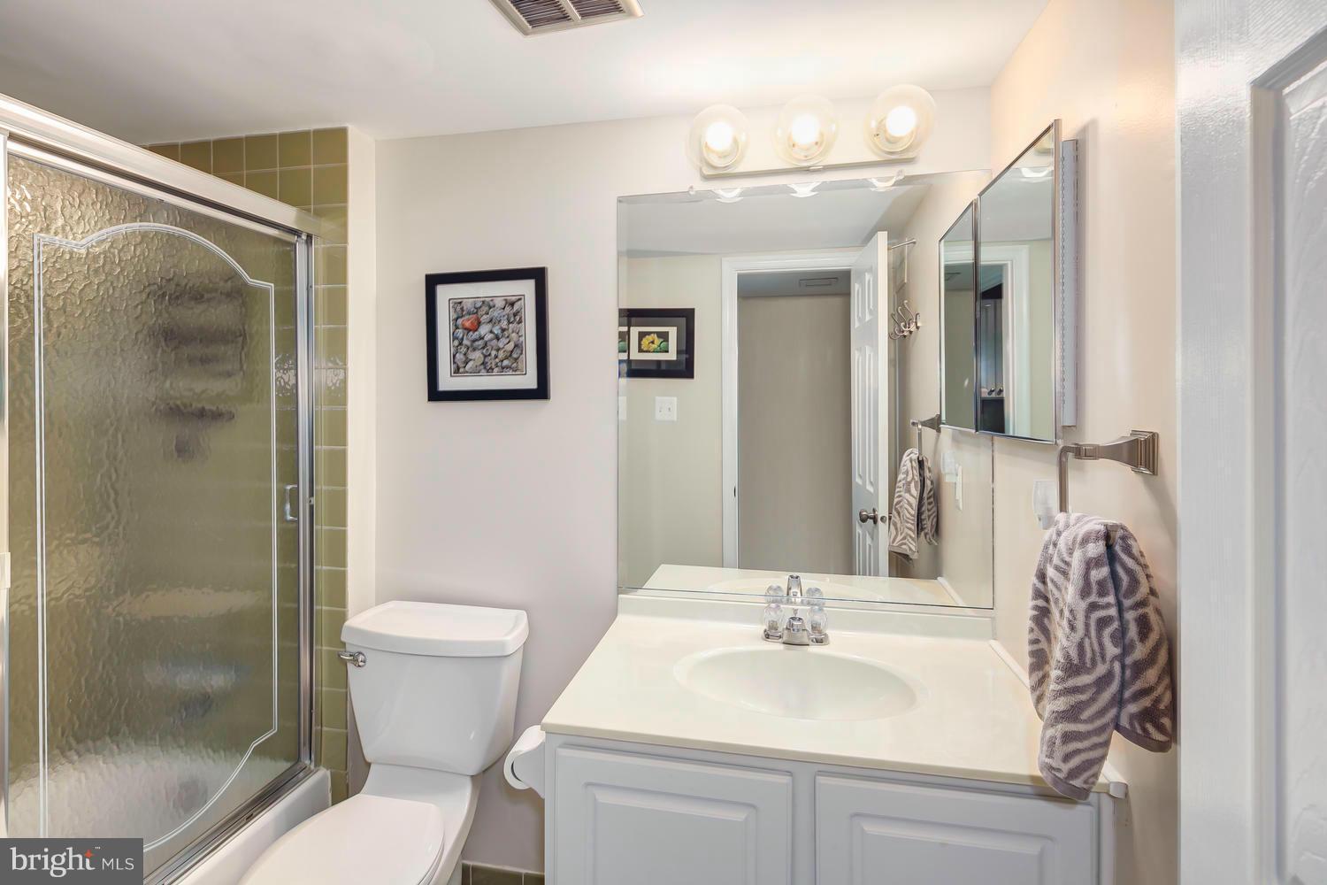 9148 Rockefeller Lane Springfield, VA 22153 - Photo 25 of 29 a bathroom with a sink toilet and shower