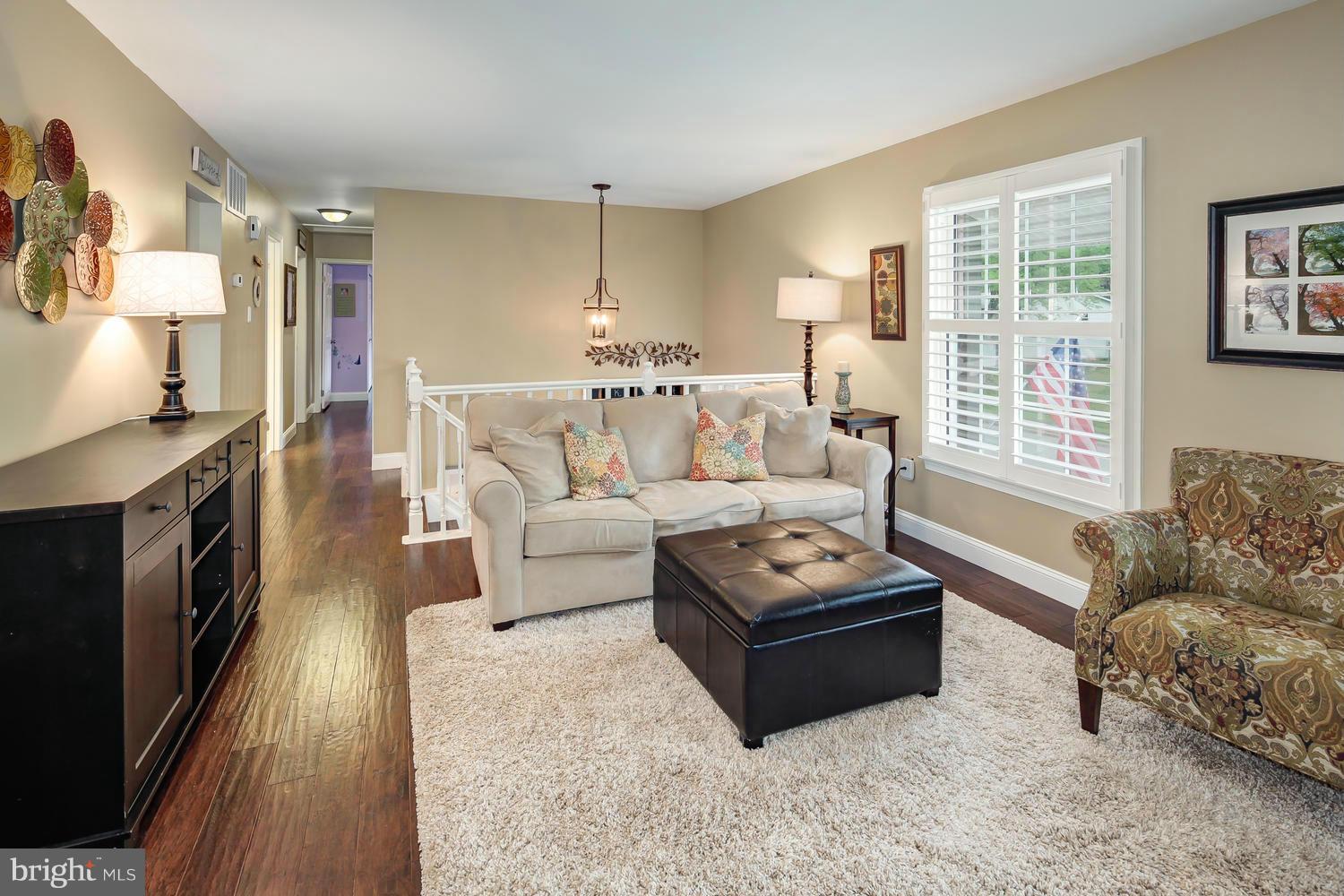 9148 Rockefeller Lane Springfield, VA 22153 - Photo 4 of 29 a living room with furniture and a fireplace