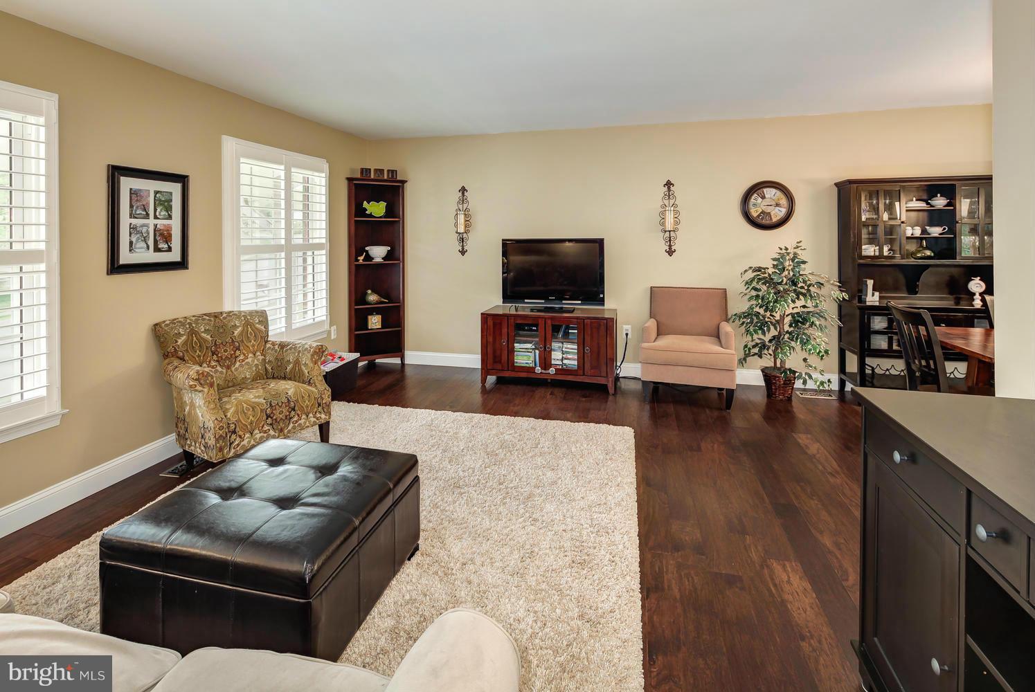 9148 Rockefeller Lane Springfield, VA 22153 - Photo 7 of 29 a living room with furniture or couch and a flat screen tv