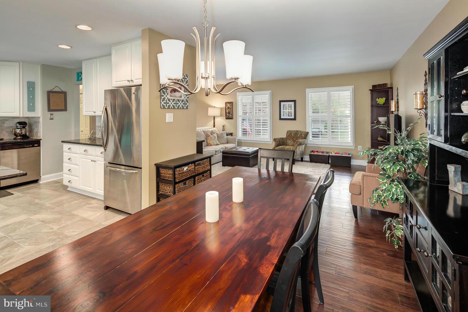 9148 Rockefeller Lane Springfield, VA 22153 - Photo 8 of 29 an open kitchen with wooden floor and refrigerator