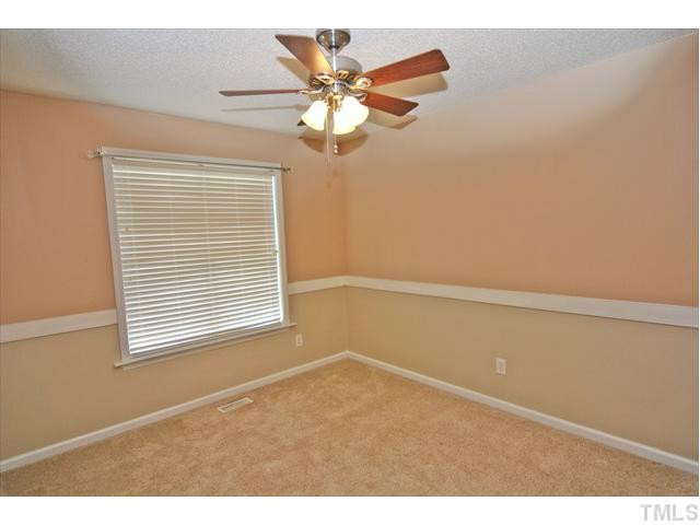 144 Wagner Road Willow Spring, NC 27592 - Photo 14 of 19 a view of an empty room with a window