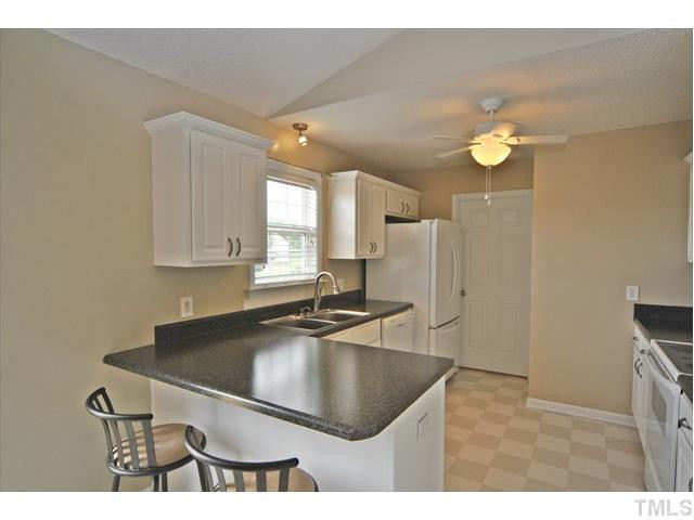 144 Wagner Road Willow Spring, NC 27592 - Photo 3 of 19 a kitchen with kitchen island a sink stainless steel appliances and cabinets