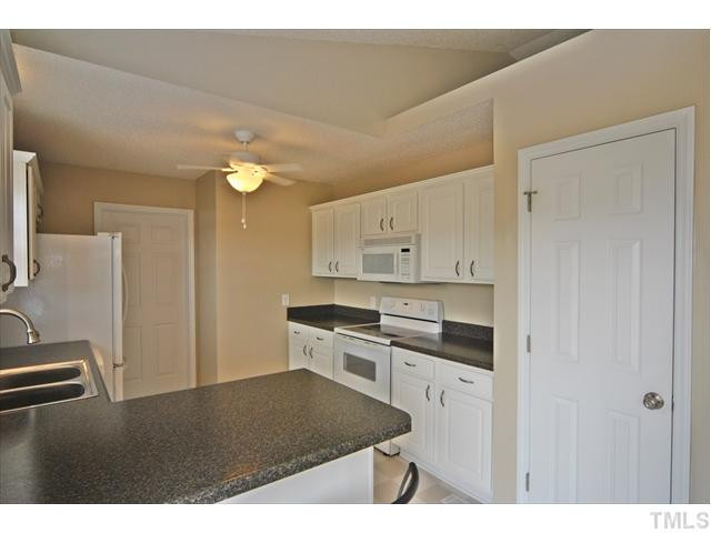 144 Wagner Road Willow Spring, NC 27592 - Photo 8 of 19 a kitchen with kitchen island a sink stainless steel appliances and cabinets