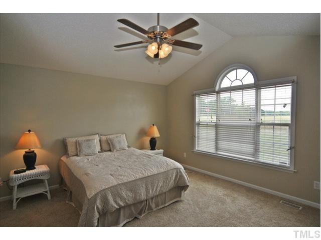 144 Wagner Road Willow Spring, NC 27592 - Photo 10 of 19 a bedroom with a bed and window