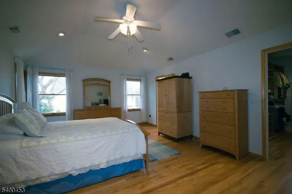 a bedroom with a bed closet and a window