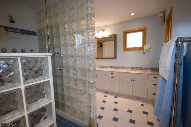 a bathroom with a shower and a sink