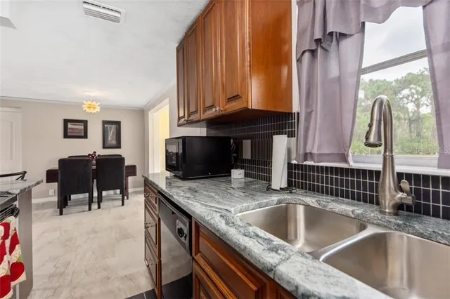 a kitchen with a sink cabinets and a stove