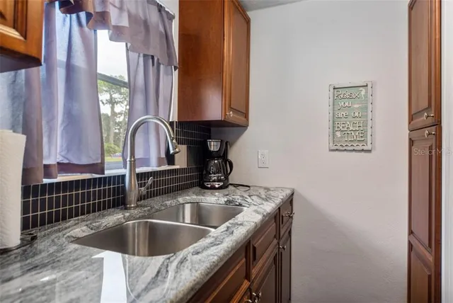 a kitchen with a sink and a window
