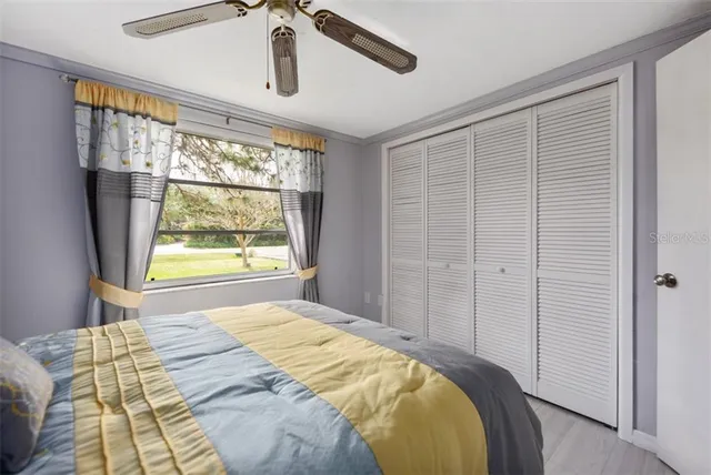 a bed sitting in a bedroom next to a window