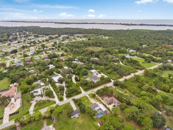 an aerial view of residential houses with yard