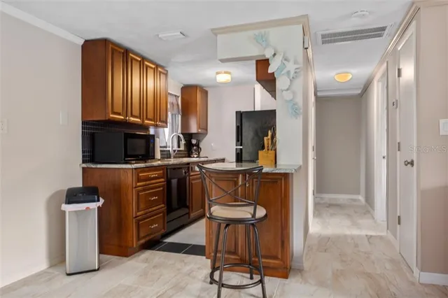 a kitchen with refrigerator cabinets and a sink