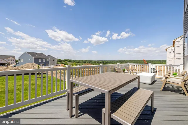 a view of a balcony with wooden floor and city view