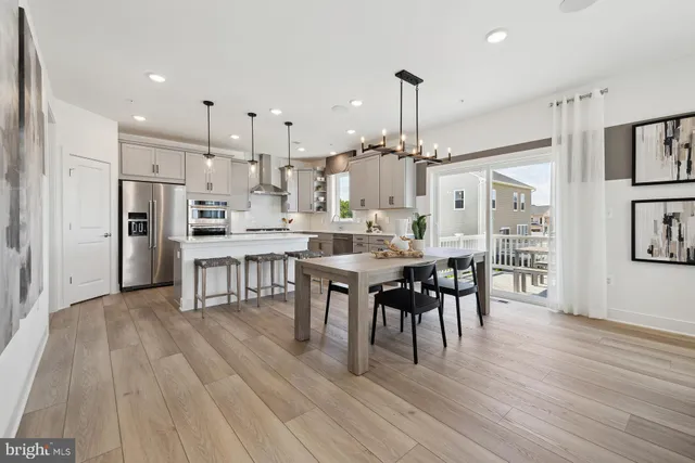 a large kitchen with cabinets table and chairs