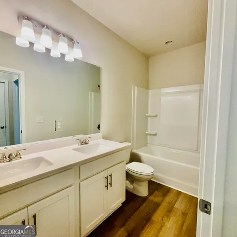 a view of a lake with a yard and large trees