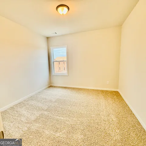 a front view of a house with a garden and plants