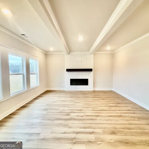 a large kitchen with kitchen island white cabinets and stainless steel appliances