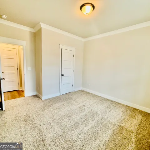 a bathroom with a sink a toilet and a large mirror