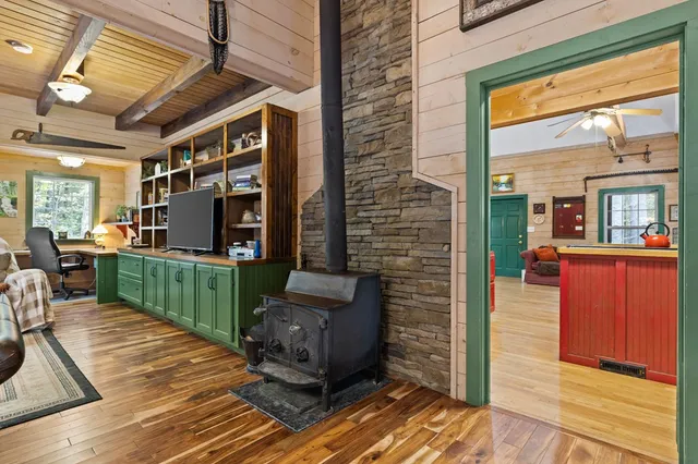 a view of a workspace with furniture and a window