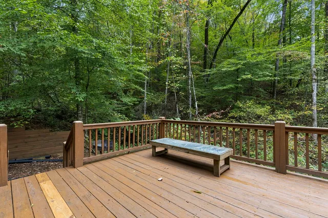 a view of balcony with wooden floor and fence