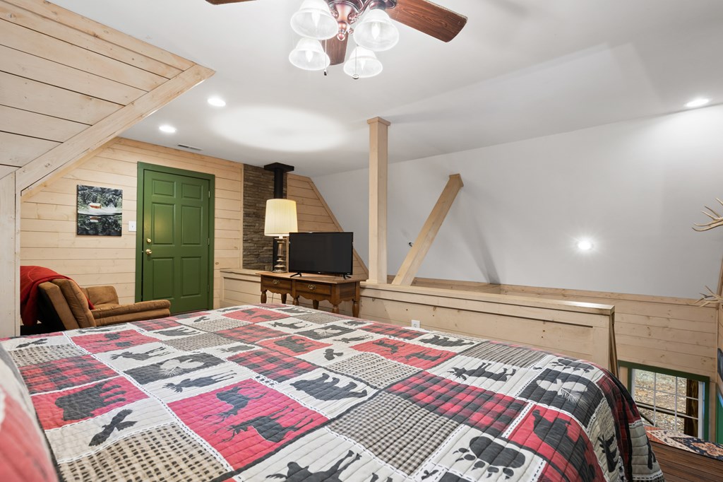 540 Old Mill Road Suches, GA 30572 - Photo 20 of 51 a bedroom with a bed and a flat screen tv