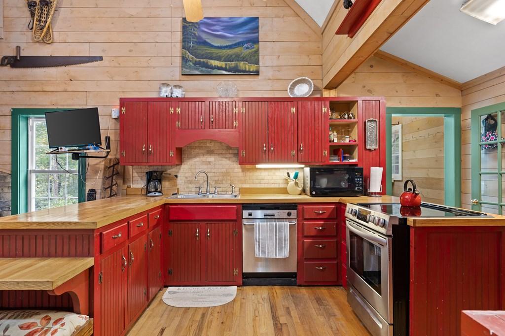 540 Old Mill Road Suches, GA 30572 - Photo 2 of 51 a kitchen with stainless steel appliances granite countertop a stove a sink dishwasher and cabinets with wooden floor