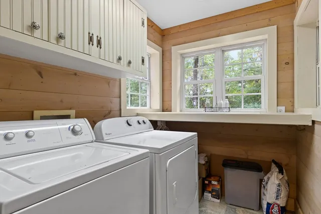 a living room with furniture a wooden floor and a window