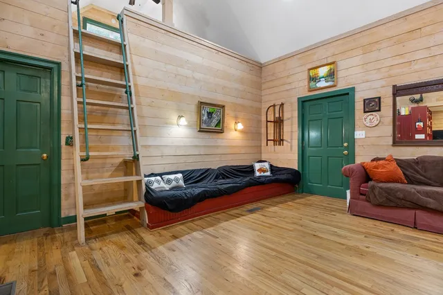 a bedroom with two beds and window