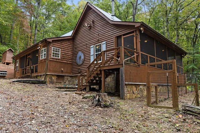 a view of a house with a patio and wooden fence