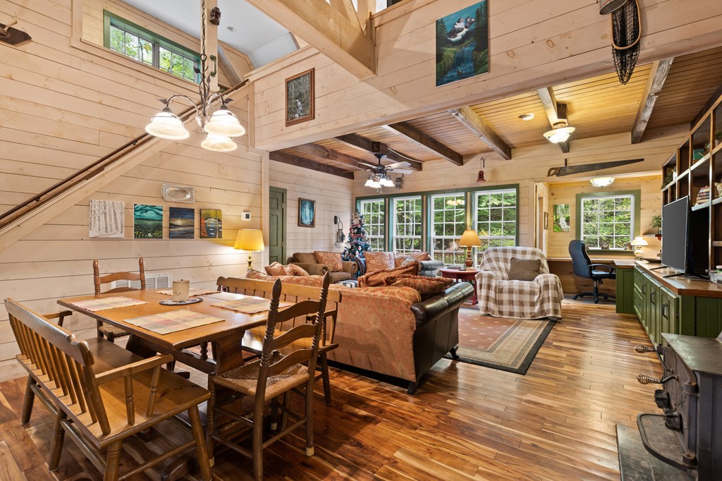 540 Old Mill Road Suches, GA 30572 - Photo 10 of 51 a view of a patio with dining table and chairs with wooden floor and fence