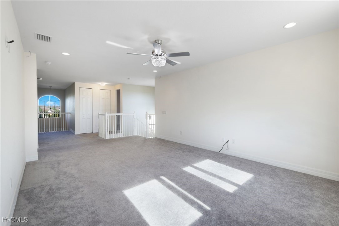 11727 Kati Falls Lane Fort Myers, FL 33913 - Photo 18 of 48 an empty room with fan and windows