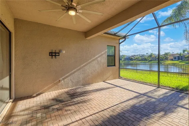 a view of an empty room with a floor to ceiling windows with a ceiling fan