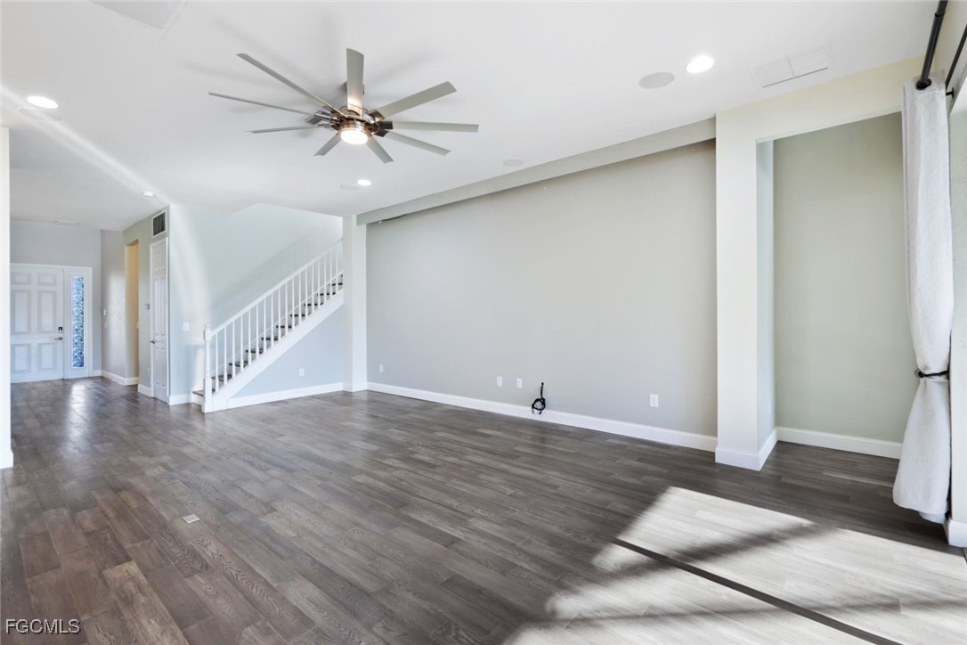 11727 Kati Falls Lane Fort Myers, FL 33913 - Photo 6 of 48 a view of an empty room with wooden floor and a ceiling fan