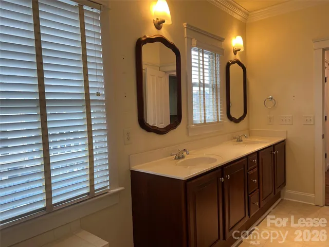 a bathroom with a double vanity sink and a mirror